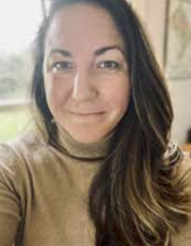 Close-up portrait of Jennifer Marsh in a beige turtleneck, indoors with soft background.