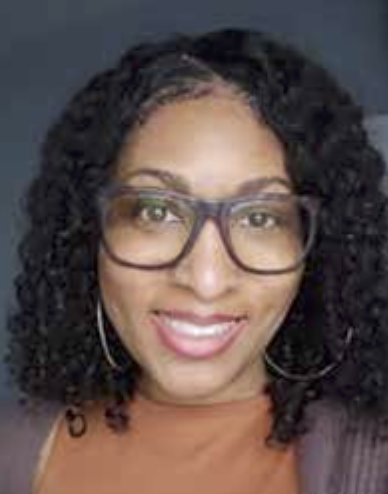 Portrait of Jordana Cunningham  with curly hair wearing glasses and hoop earrings.