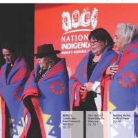 June 2024 cover: Four Indigenous women draped with gift blankets on stage.